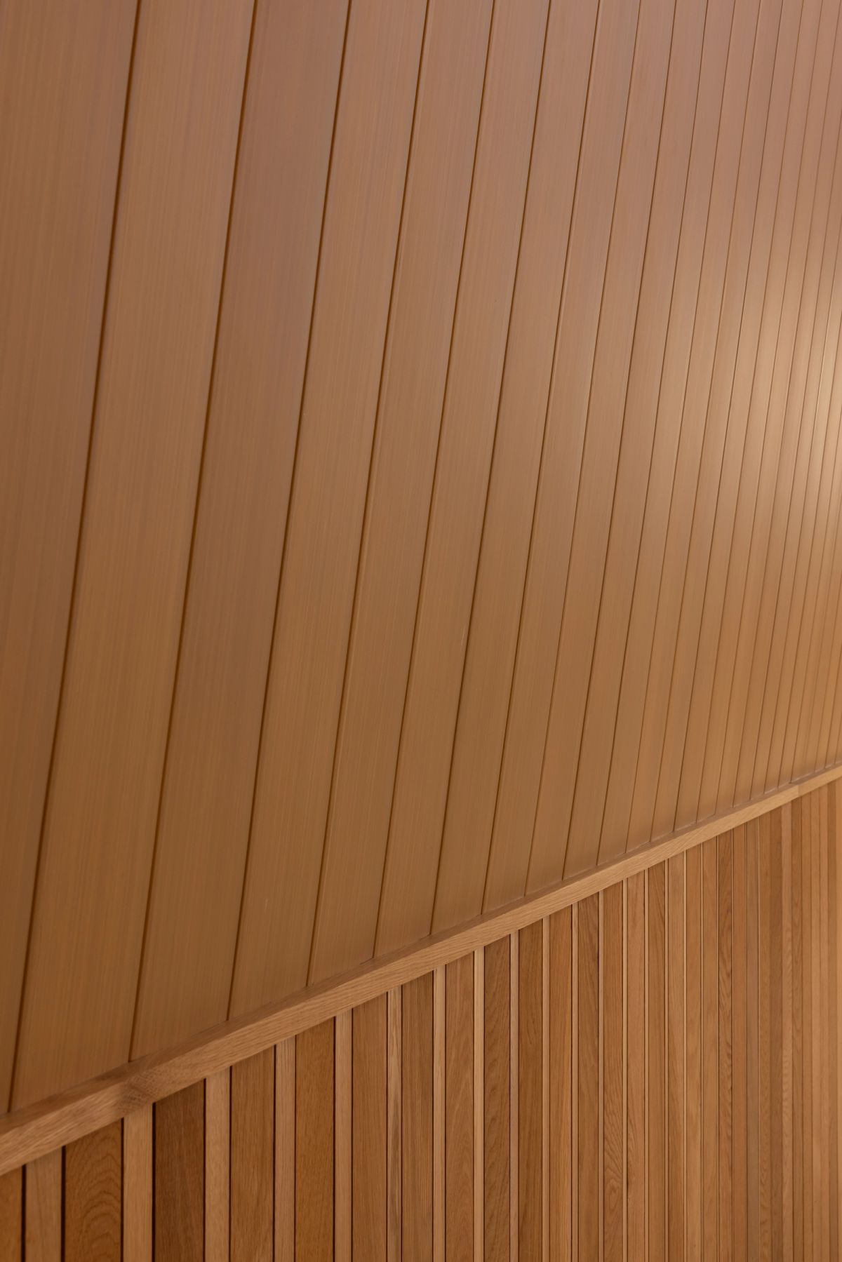 Close detail of InnoCeil timber ceiling boards meeting the wall lining